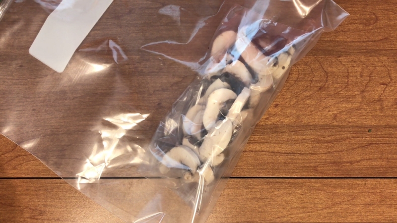 Sliced mushrooms are packed in a freezer bag for long-term storage