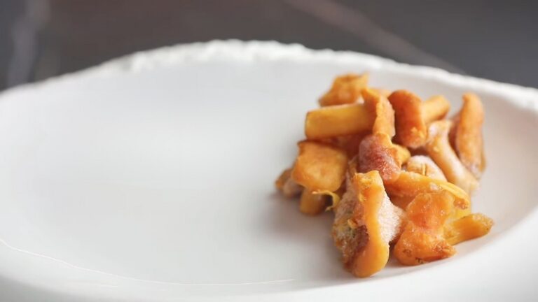 Frozen mushrooms on a white plate ready for cooking